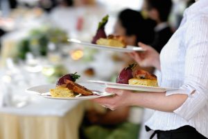 restaurant worker holding plates